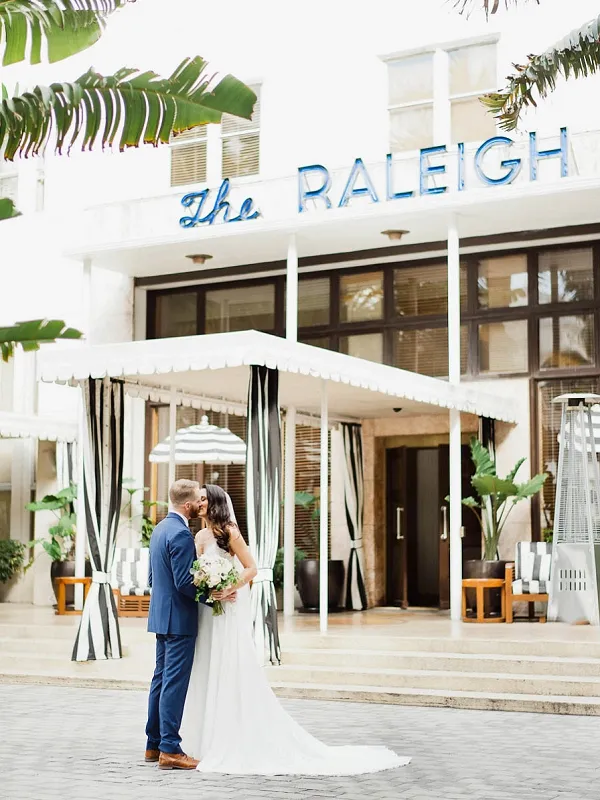 Bride and groom with vintage car in the Art Deco District