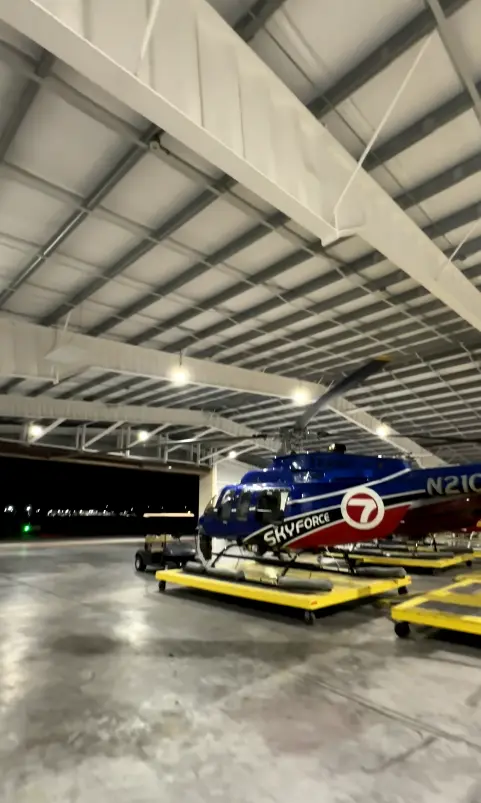 SkyForce helicopter inside a Miami hangar at night