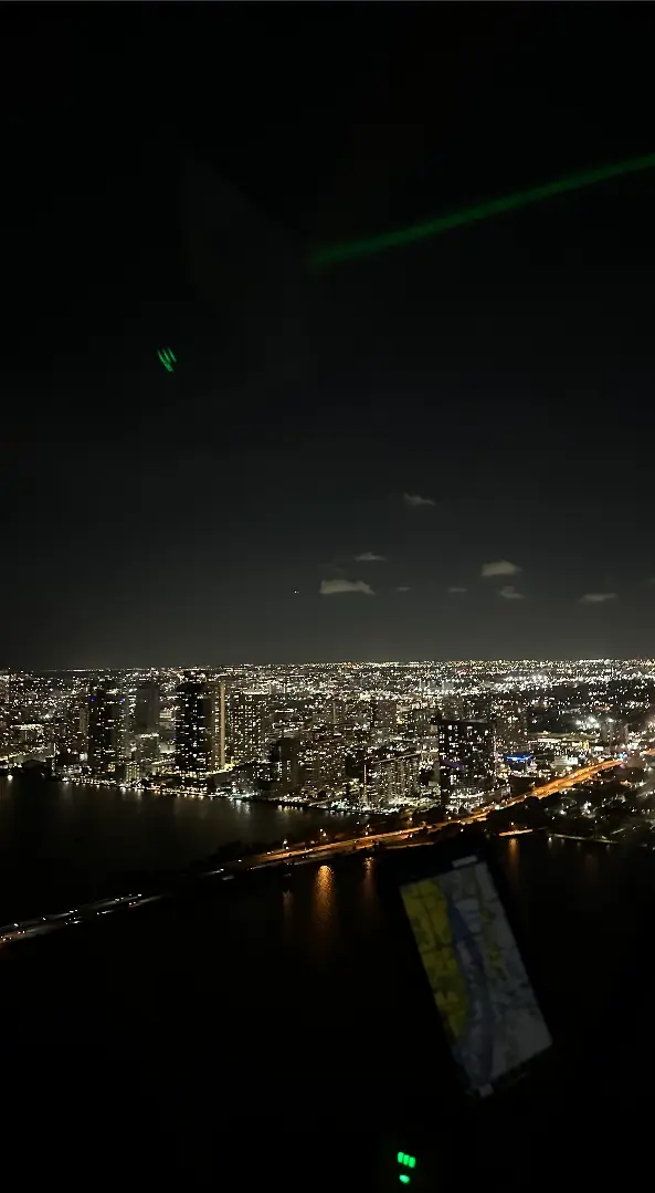 Aerial night view of Brickell and Biscayne Bay with city lights
